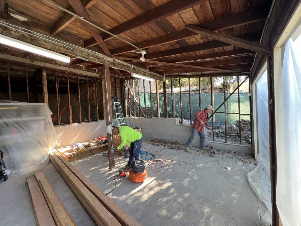 - Oasis Builders, Inc. Garage conversion under construction with framing and utility rough-ins