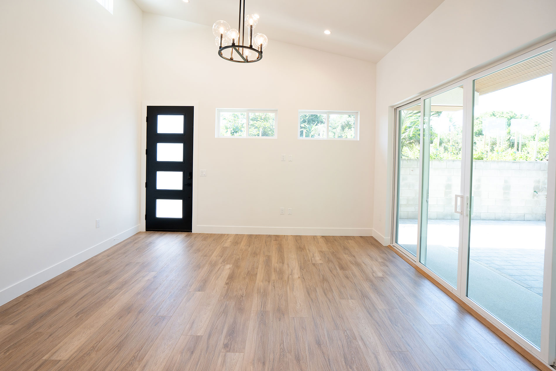 - Oasis Builders, Inc. ADU Living Room with Vaulted Ceilings and Large Sliding Doors