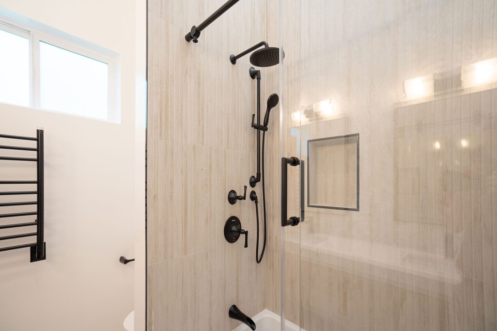 - Oasis Builders, Inc. ADU Shower Kenridge Ribbon Maple Porcelain Wood Look Tile