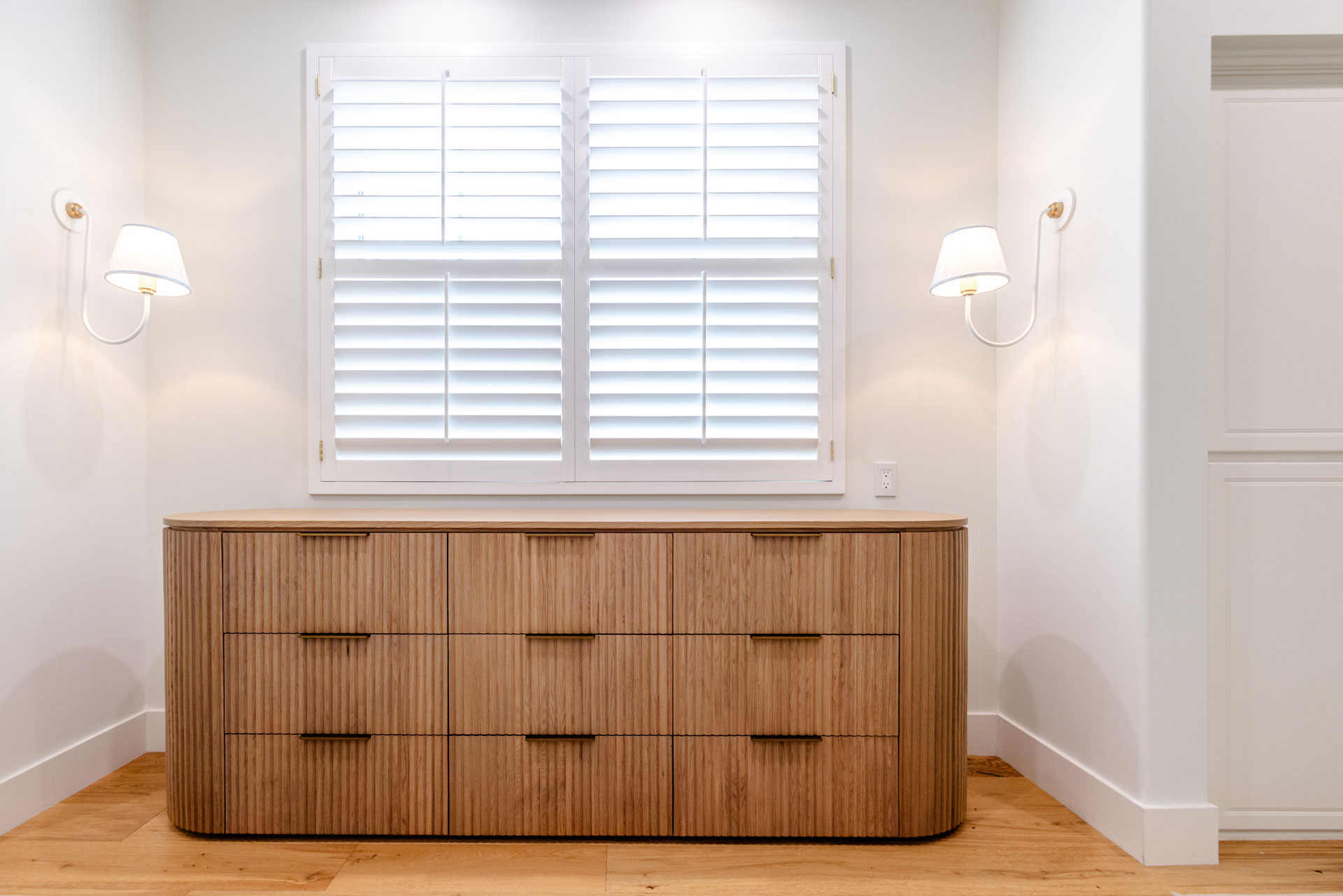 - Oasis Builders, Inc. Marina Del Rey Master Bathroom Renovation Fluted wood dresser with white sconces