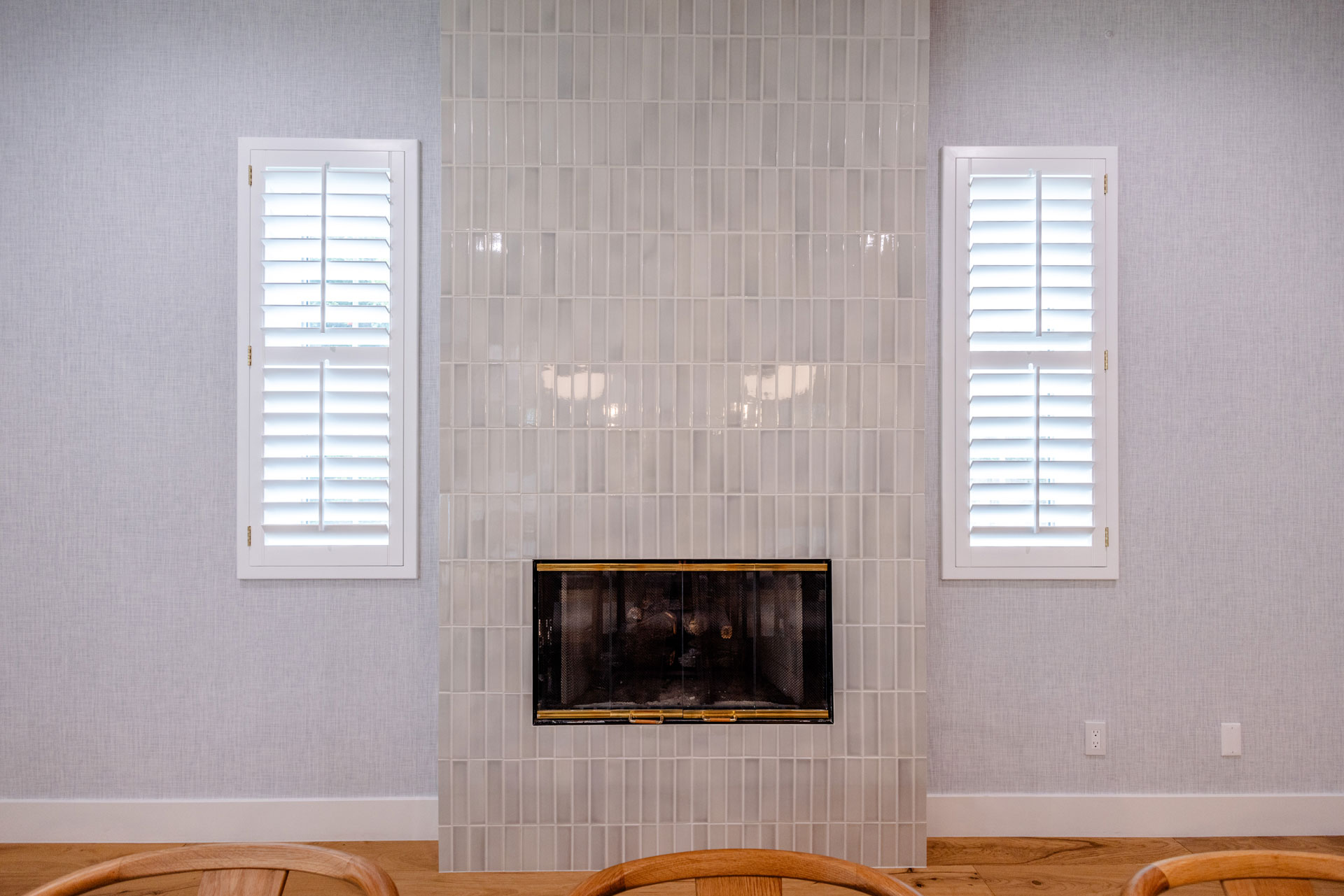 - Oasis Builders, Inc. Updated fireplace with vertical stacked tile living room renovation