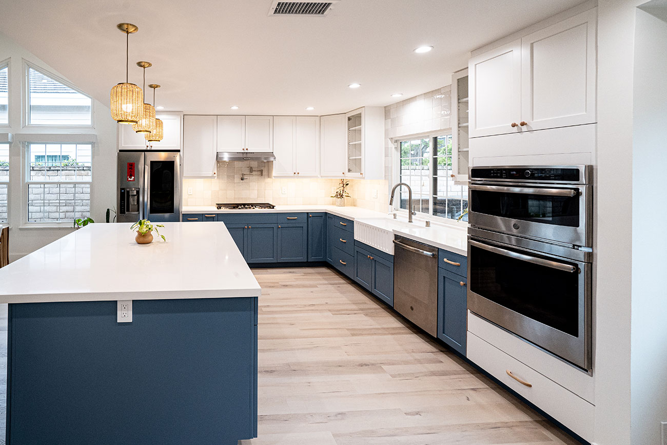 - Oasis Builders, Inc. Frameless kitchen cabinets in blue for the lowers