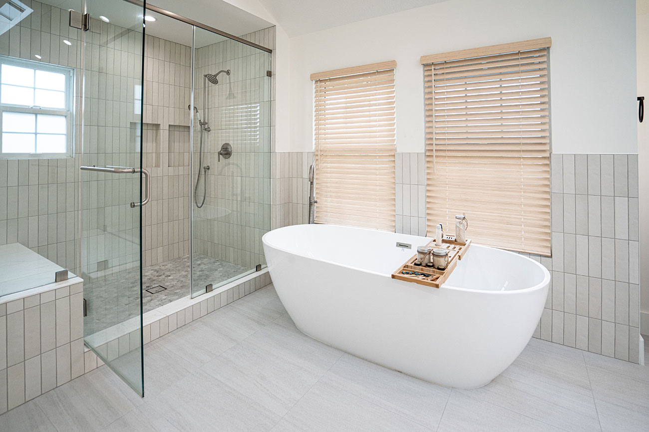 - Oasis Builders, Inc. Spa-like bathroom with frameless glass shower